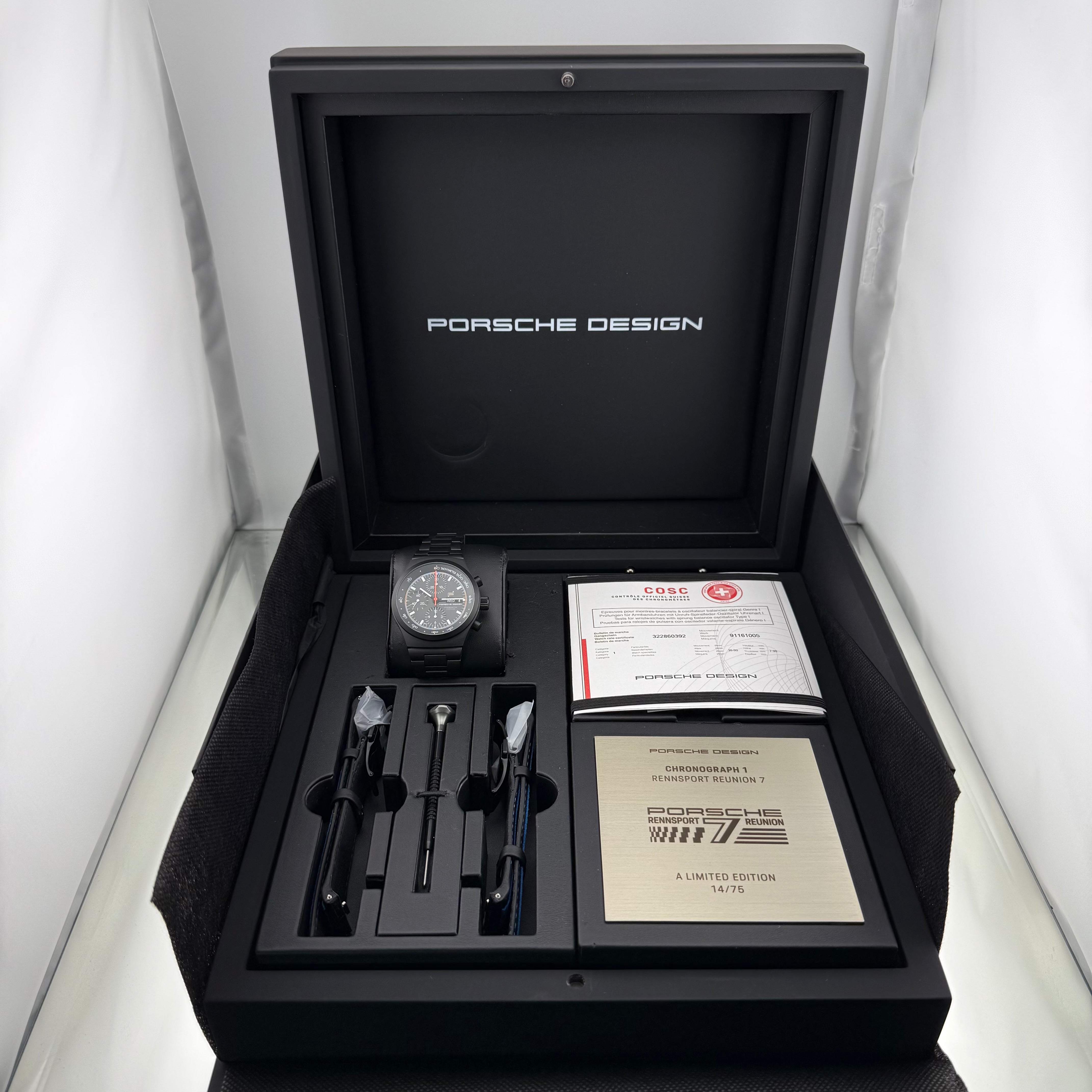 Porsche Design Chronograph 1 Rennsport Reunion 7 Edition Black Titanium Black dial with with white index hour markers and luminous black hands. Three black chronograph sub-dials. Day & date windows at 3 o’clock. Dial 6041.7.01.004.01.5